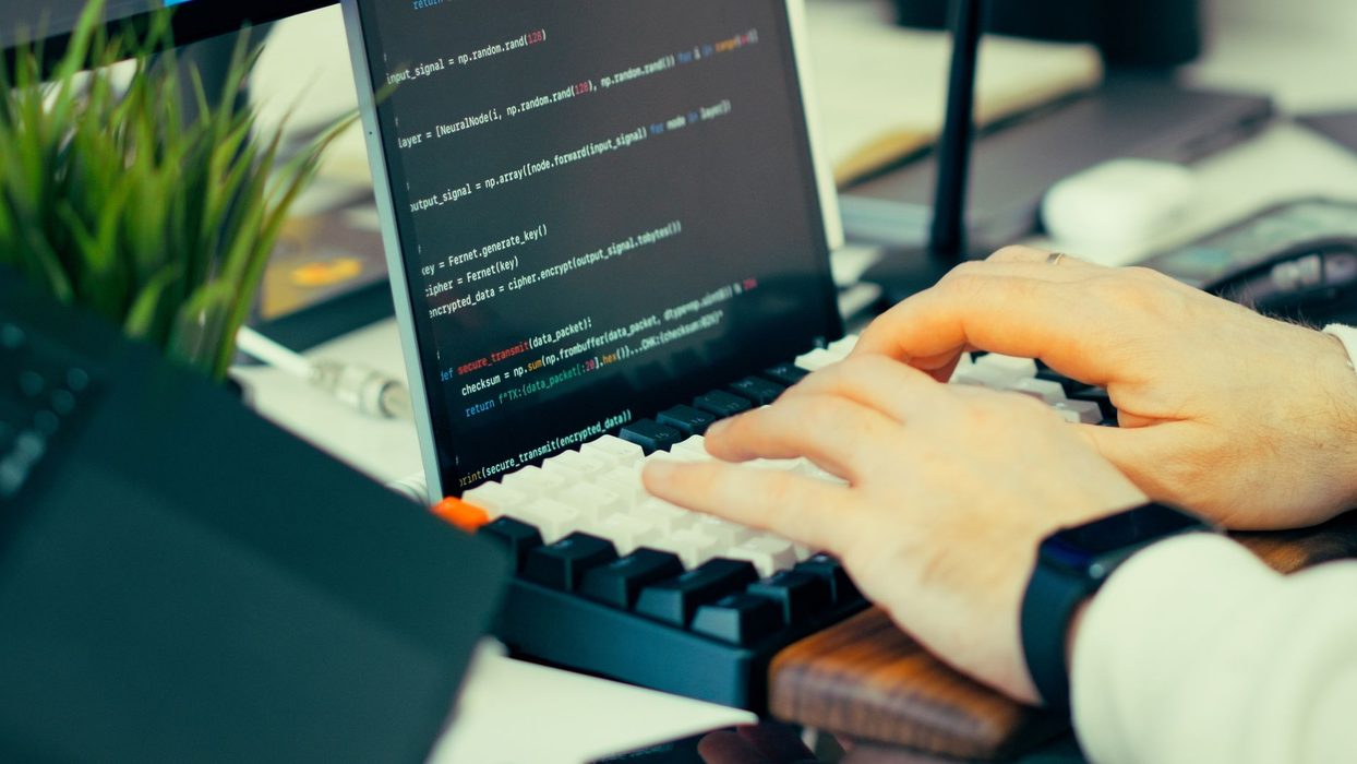 A person reviewing command line output on a laptop screen